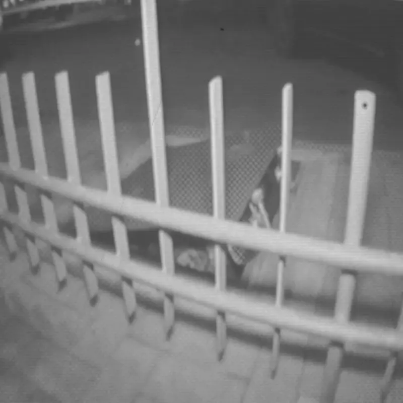 Black-and-white scene of a person in CNTRL shoes skateboarding on a metal fence, conveying an urban, gritty vibe.