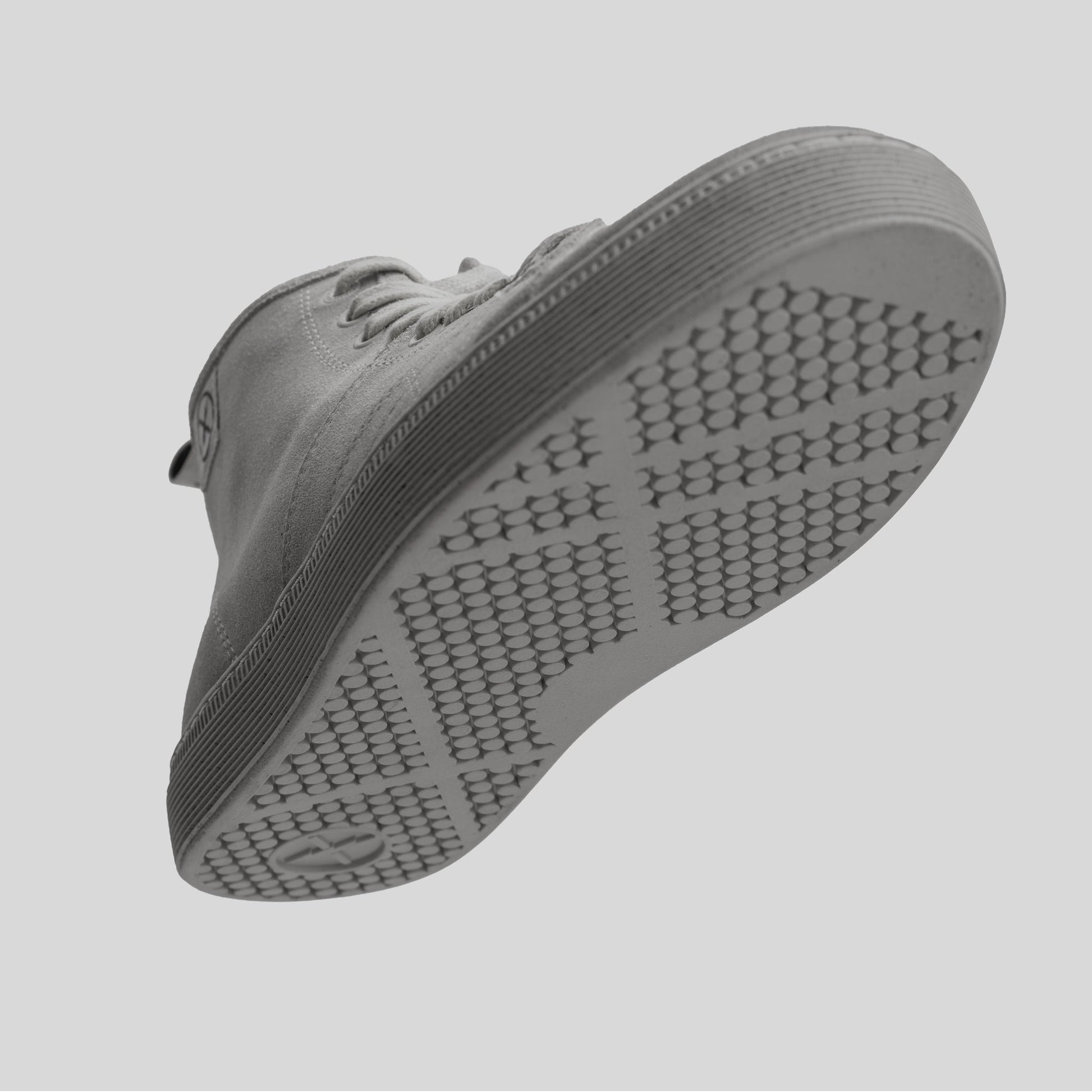 Underside view of the CNTRL boot sole in Dirty White Suede