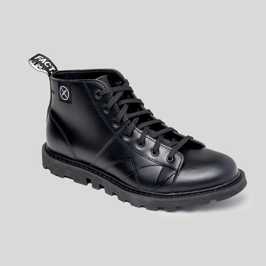 Black leather monkey boot with brand logo on a light gray background