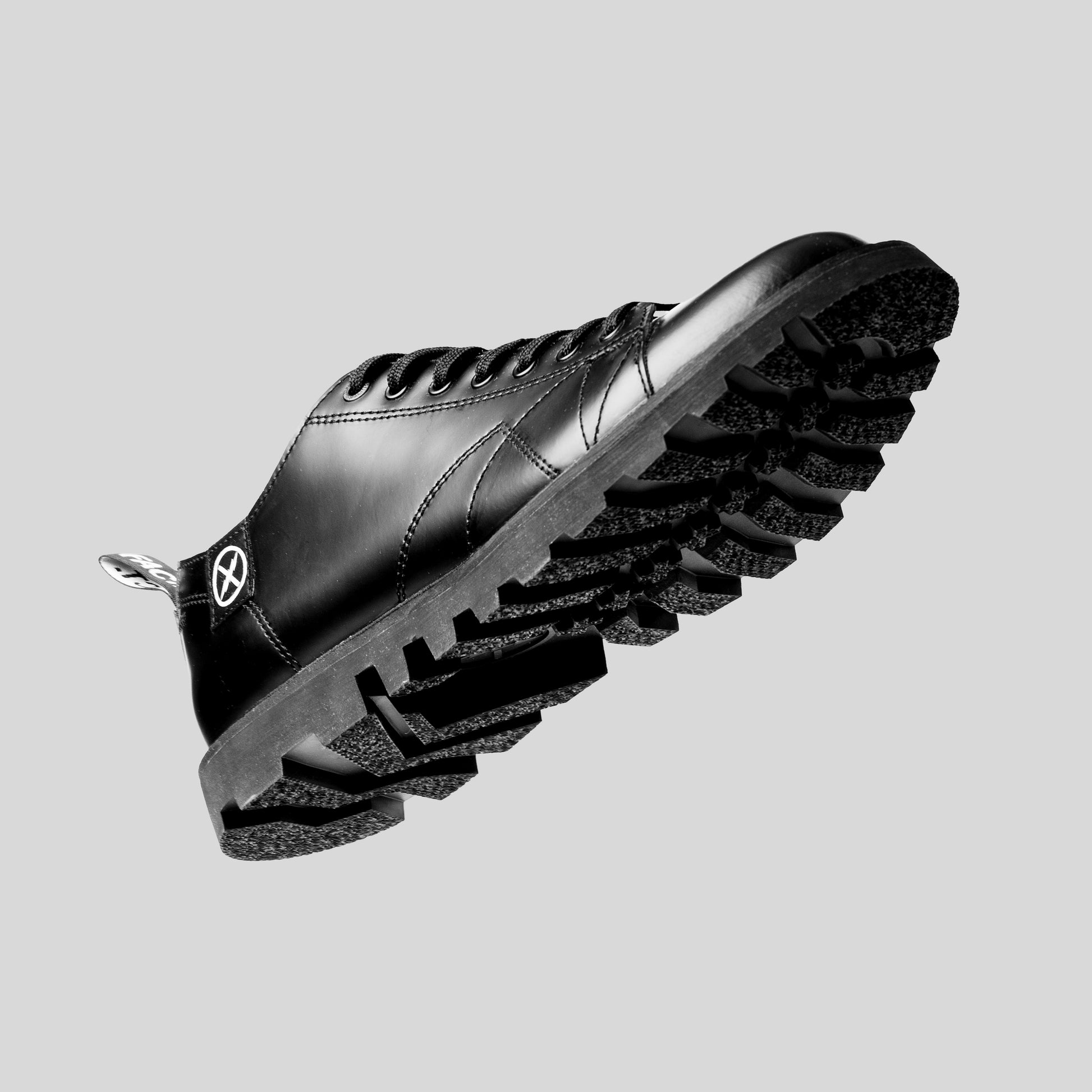 Underside view of the FACT. MNKY Shoe showing the rugged tractor-style outsole tread.